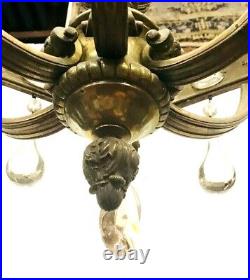 Lustre double étage en bronze ciselé décor de têtes bras de lumière. XIX siècle