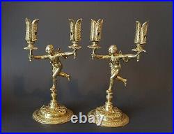Paire de candélabres, en bronze doré supportée par des amours fin XIX ème siècle