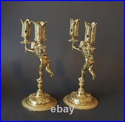 Paire de candélabres, en bronze doré supportée par des amours fin XIX ème siècle