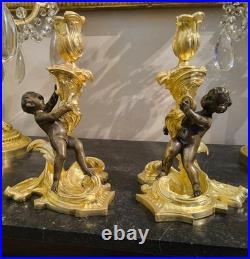 Paire de flambeaux aux putti, style Louis XV, d'après Meissonnier XIXe siècle