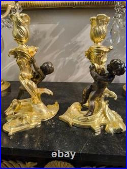 Paire de flambeaux aux putti, style Louis XV, d'après Meissonnier XIXe siècle