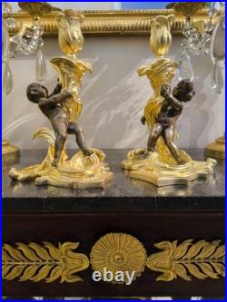 Paire de flambeaux aux putti, style Louis XV, d'après Meissonnier XIXe siècle