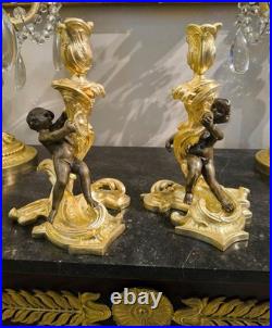 Paire de flambeaux aux putti, style Louis XV, d'après Meissonnier XIXe siècle
