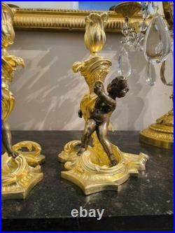 Paire de flambeaux aux putti, style Louis XV, d'après Meissonnier XIXe siècle