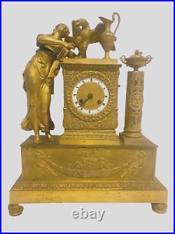 Pendulette en bronze doré personnage féminin et aigle royal. XIX siècle