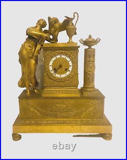 Pendulette en bronze doré personnage féminin et aigle royal. XIX siècle