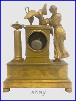 Pendulette en bronze doré personnage féminin et aigle royal. XIX siècle